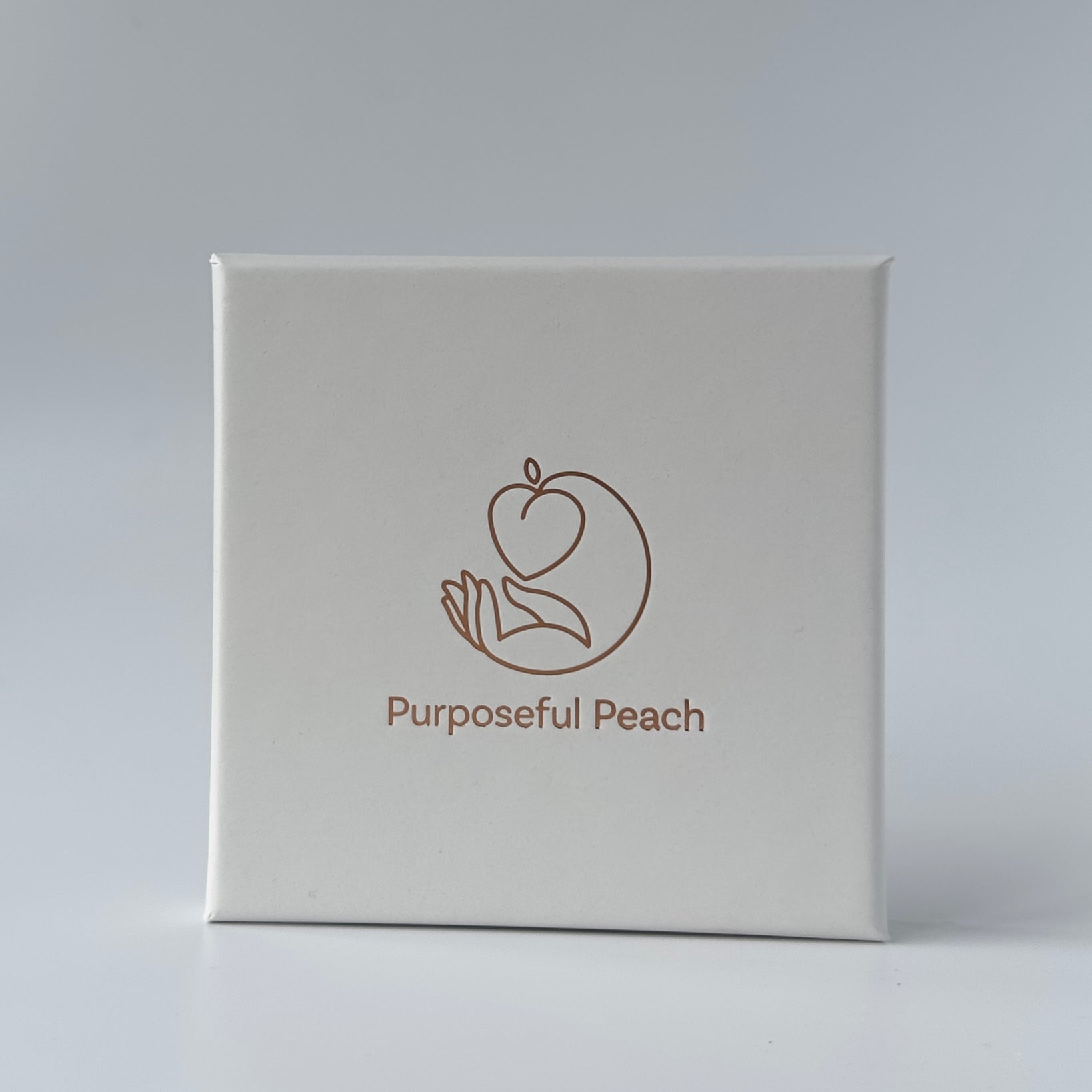 White box with 'Purposeful Peach' logo on a light gray background