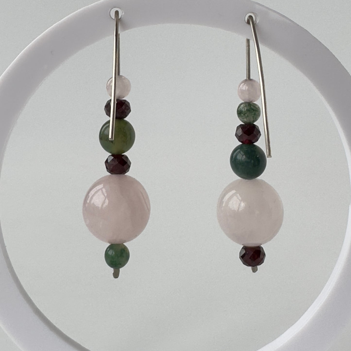Pair of earrings with beads on a white background