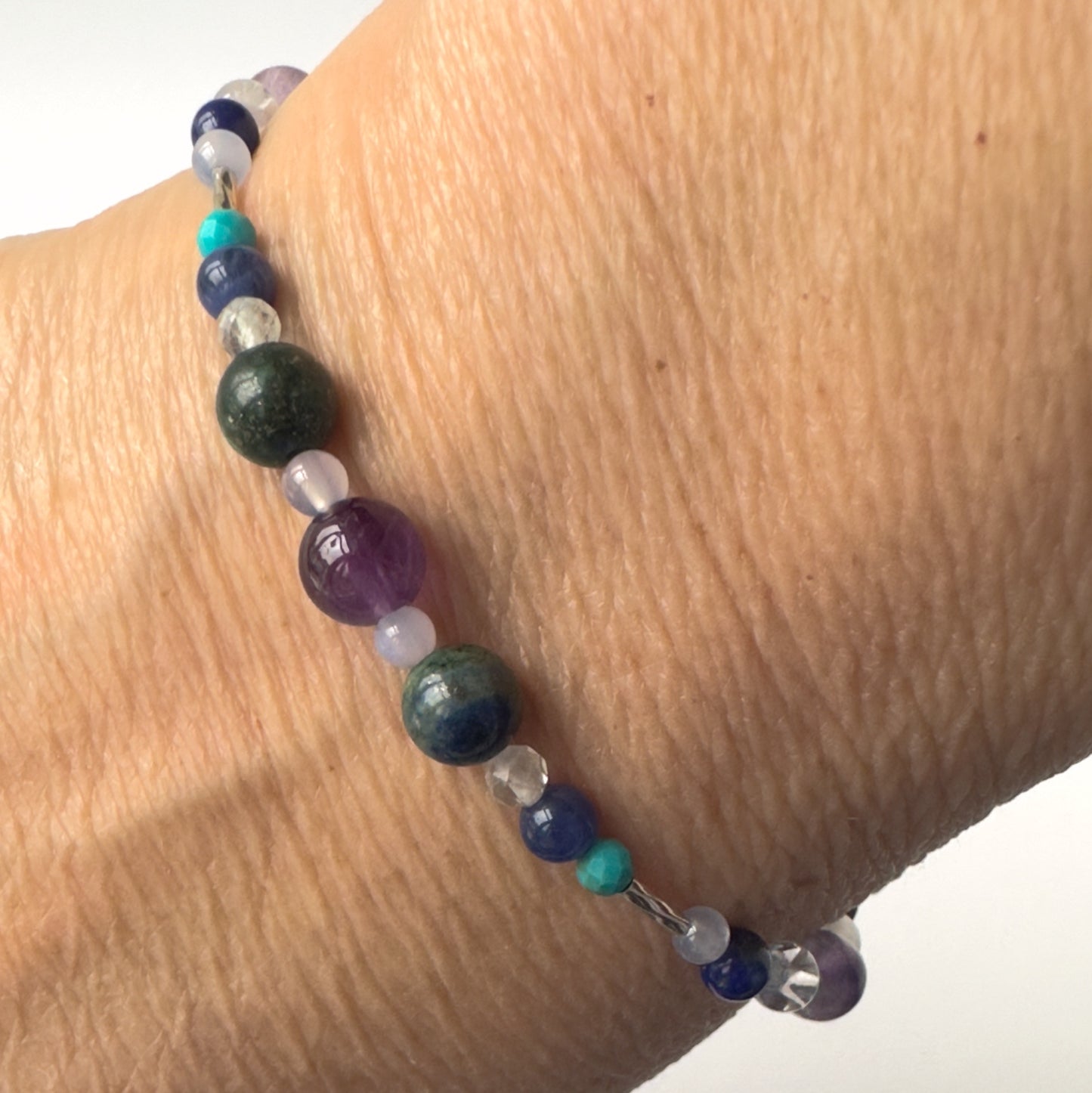 Sagittarius Healing Crystal bracelet for Anxiety on wrist showing Turquoise, Amethyst, Lapis Lazuli, Azurite, Sodalite and Blue Lace Agate
