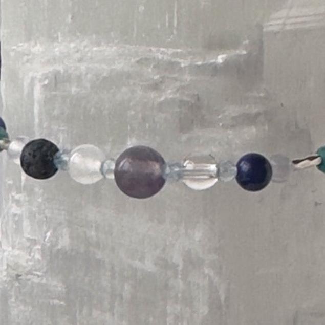 Sagittarius birthstone Healing Crystal bracelet for Calm & Anxiety Relief showing Blue Topaz, Fluorite, Sodalite, Selenite, Clear Quartz and Lava Stone