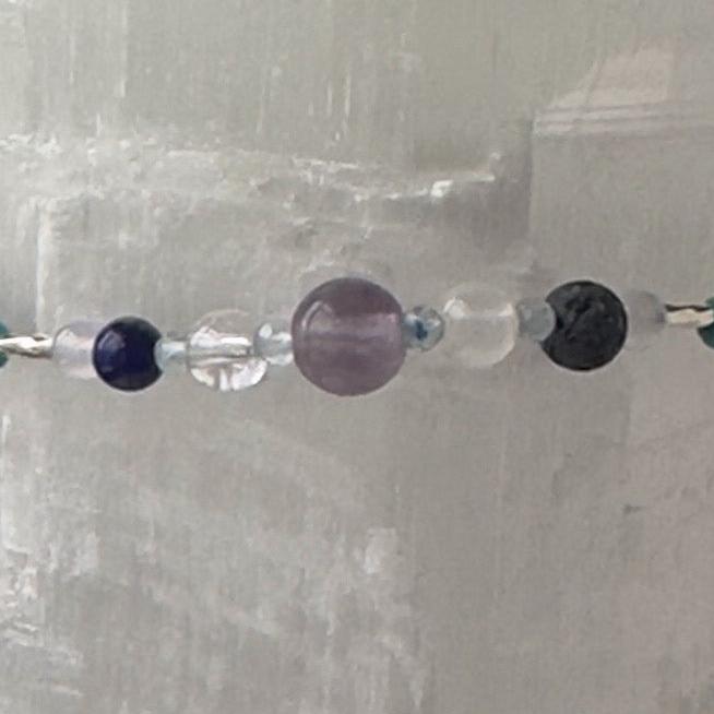 Sagittarius birthstone Healing Crystal bracelet for Calm & Anxiety Relief showing Lapis Lazuli, Blue Topaz, Fluorite, Blue Lace Agate, Selenite, Clear Quartz and Lava Stone