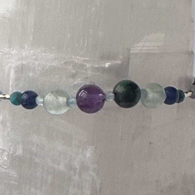 Sagittarius Birthstone Healing Crystal bracelet for Calm & Anxiety Relief showing Turquoise, Amethyst, Lapis Lazuli, Azurite, Blue Topaz, Fluorite and Sodalite