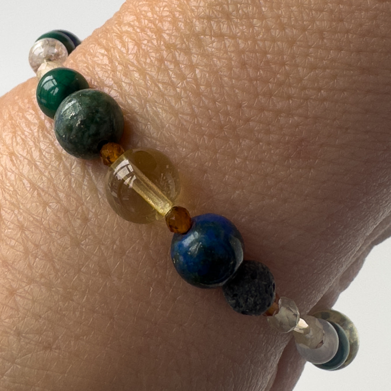 Sagittarius Birthstone Healing Crystal bracelet for Love and Compassion on wrist showing Citrine, Azurite, Garnet, malachite and Lava Stone