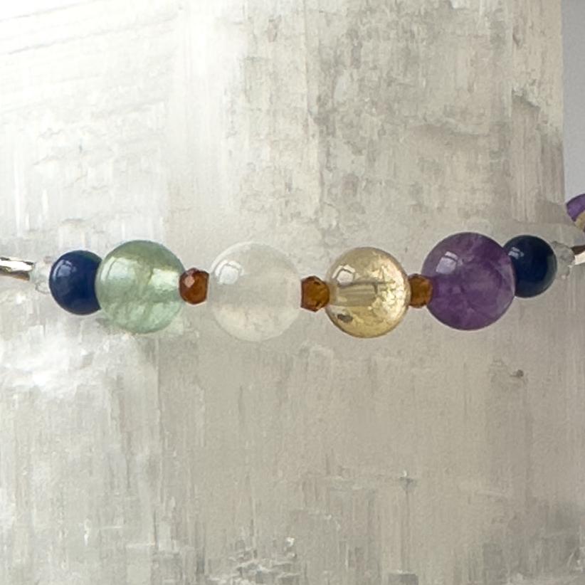 Sagittarius birthstone Healing Crystal bracelet for Determination & Willpower showing Amethyst, Rainbow Fluorite, Citrine, Sodalite, Garnet and Selenite