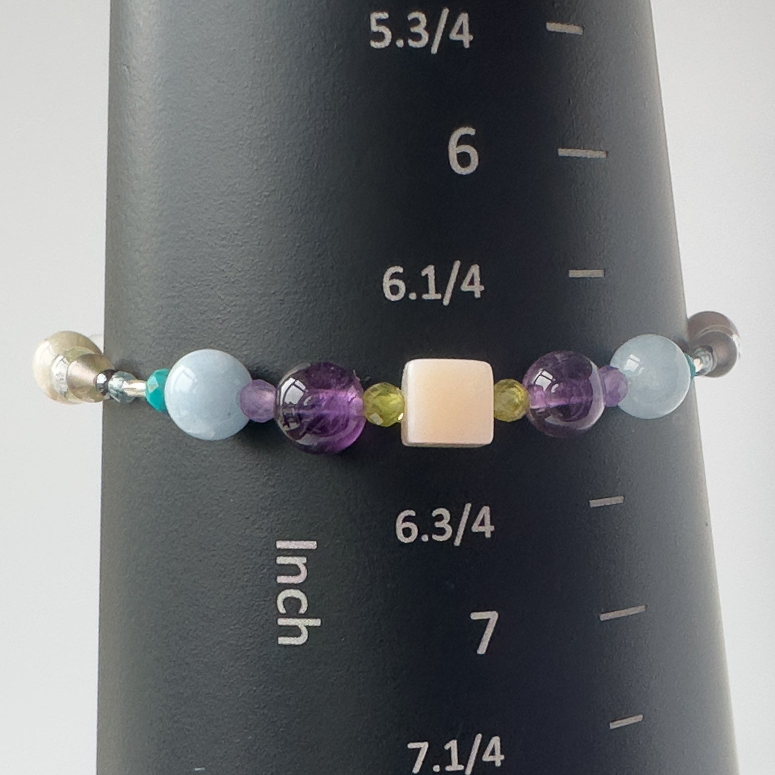 Scorpio Birthstone Healing Crystal bracelet for Calm & Stress on mandrel showing size of 6.5 inches