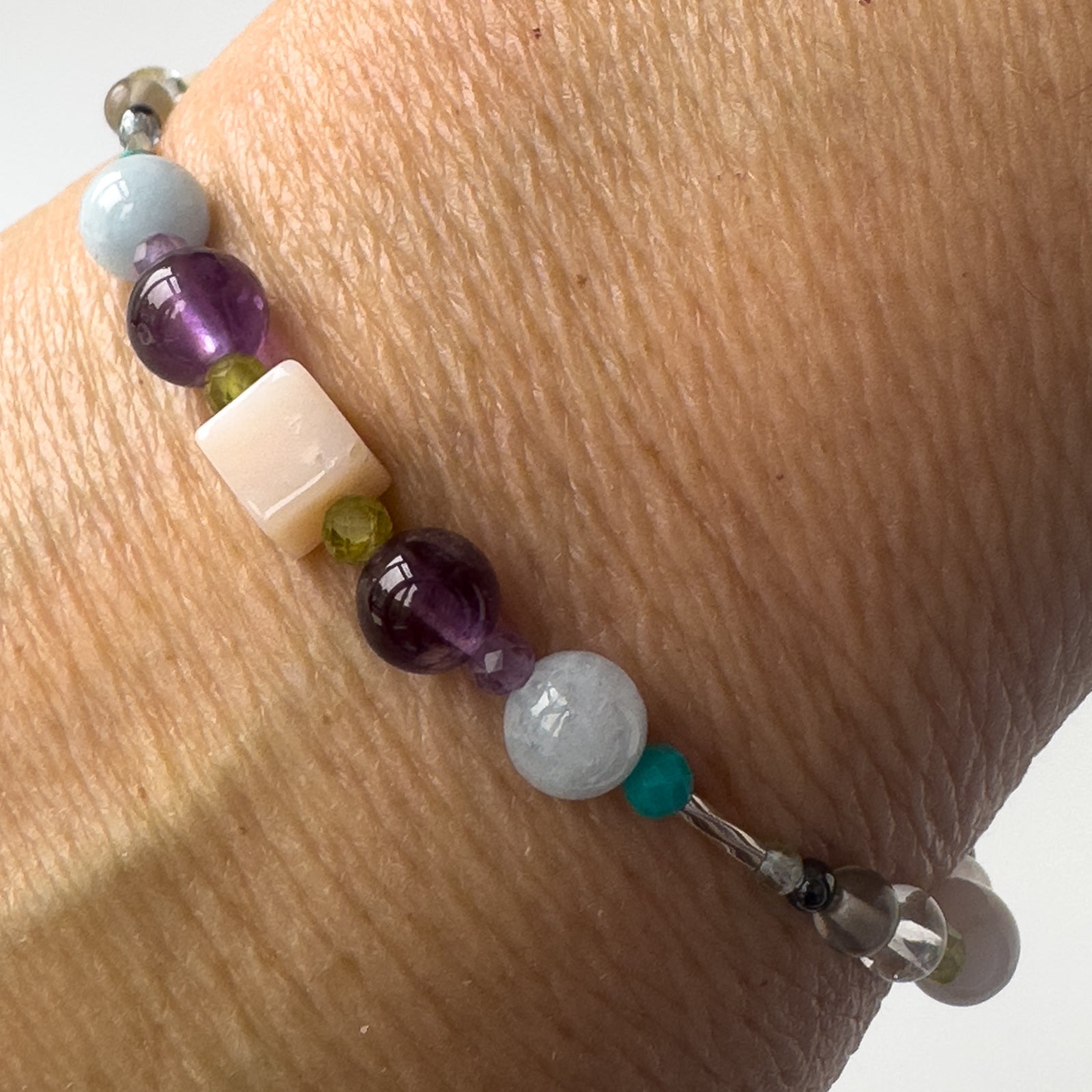 Scorpio Healing Crystal bracelet for Stress on wrist showing Pink Opal, Turquoise, Amethyst and Aquamarine