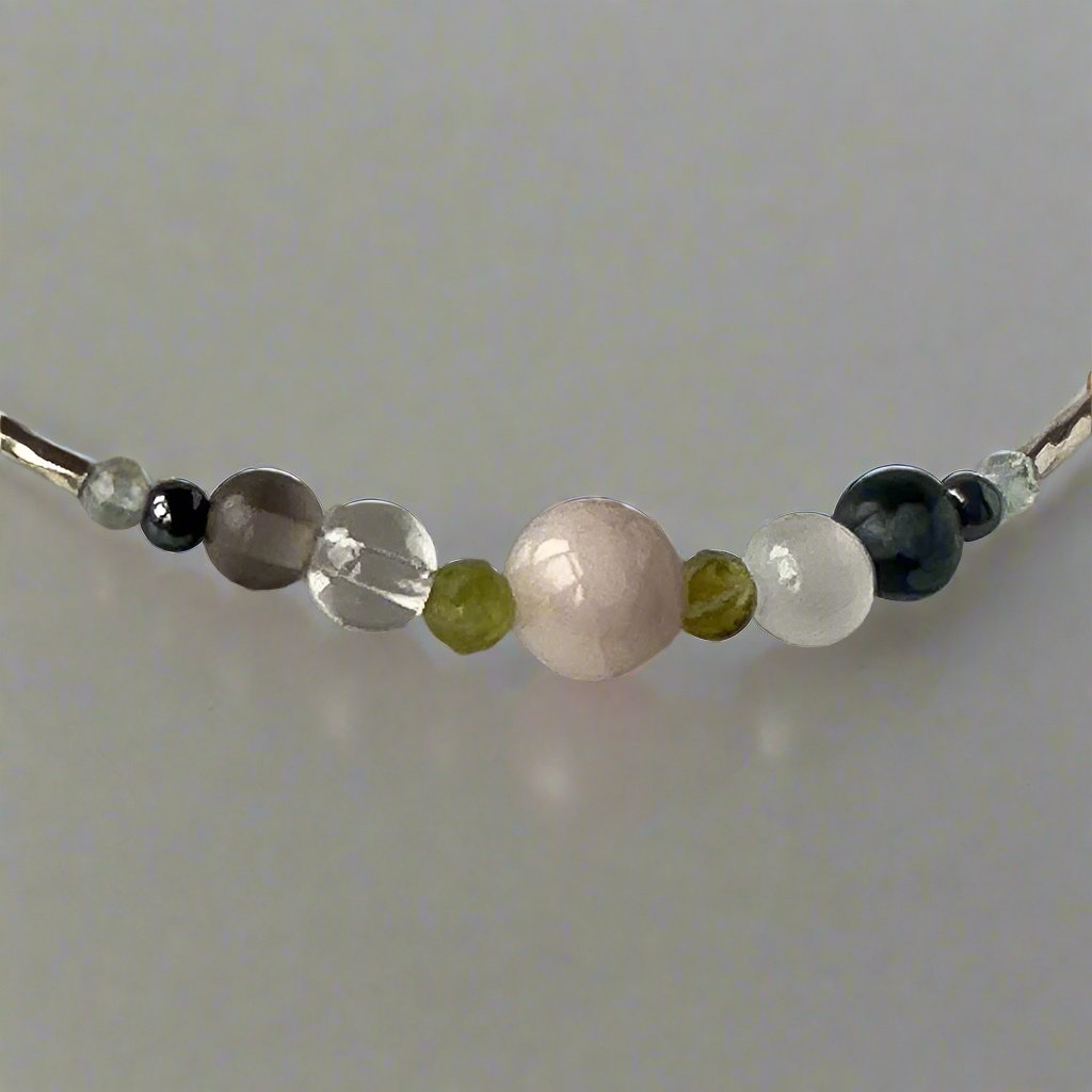 Scorpio Birthstone Healing Crystal bracelet for Calm & Stress showing Topaz, Hematite, Snowflake Obsidian, Smoky Quartz Kunzite, Selenite and Clear Quartz