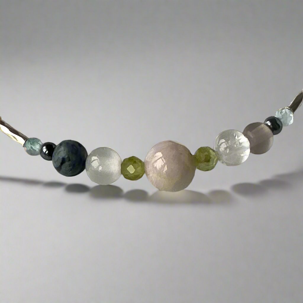 Scorpio Birthstone Healing Crystal bracelet for Calm & Stress showing Topaz, Smoky Quartz, Hematite, Peridot Kunzite, Selenite, Clear Quartz and Lava Stone