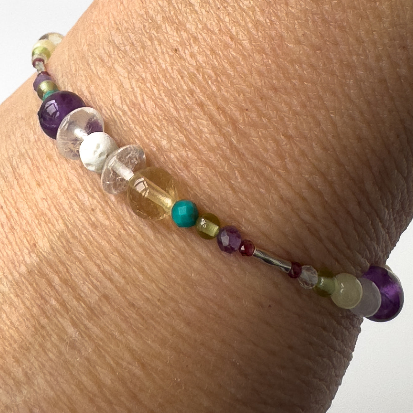 Scorpio Healing Crystal bracelet for Willpower on wrist showing Amethyst, Citrine, Turquoise, Garnet, Peridot, Clear Quartz and Lava Stone