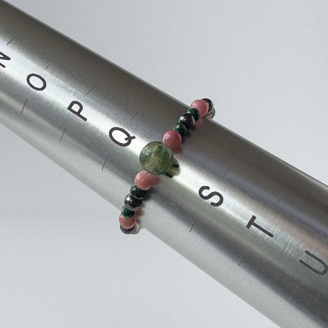 Scorpio birthstone Healing Crystal ring for Love and Compassion on mandrel showing size as R