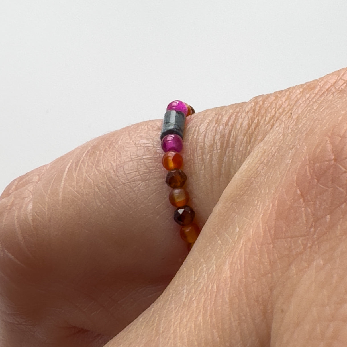 Side view of Capricorn Birthstone Healing Crystal ring for Strength and Courage on a finger