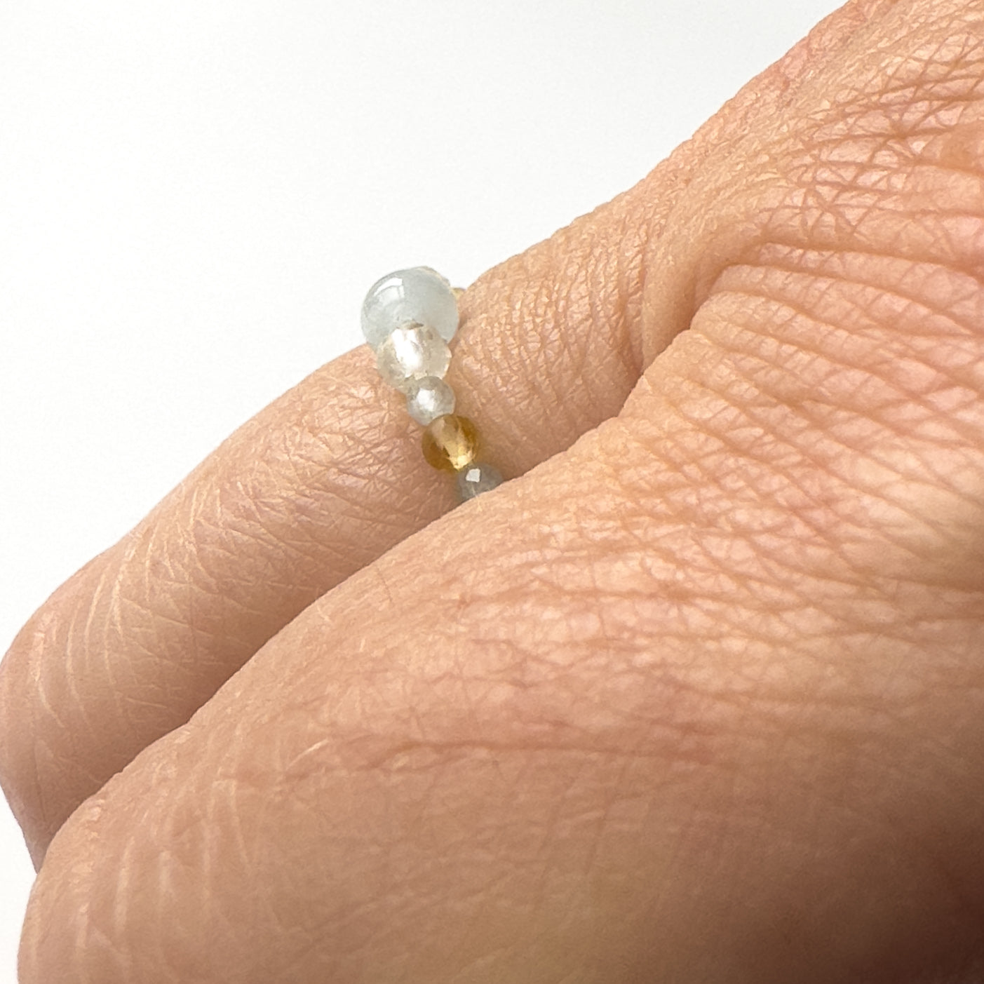 Side view of Courage Birthstone Healing Crystal ring for Gemini, Aries, Libra or Scorpio on finger