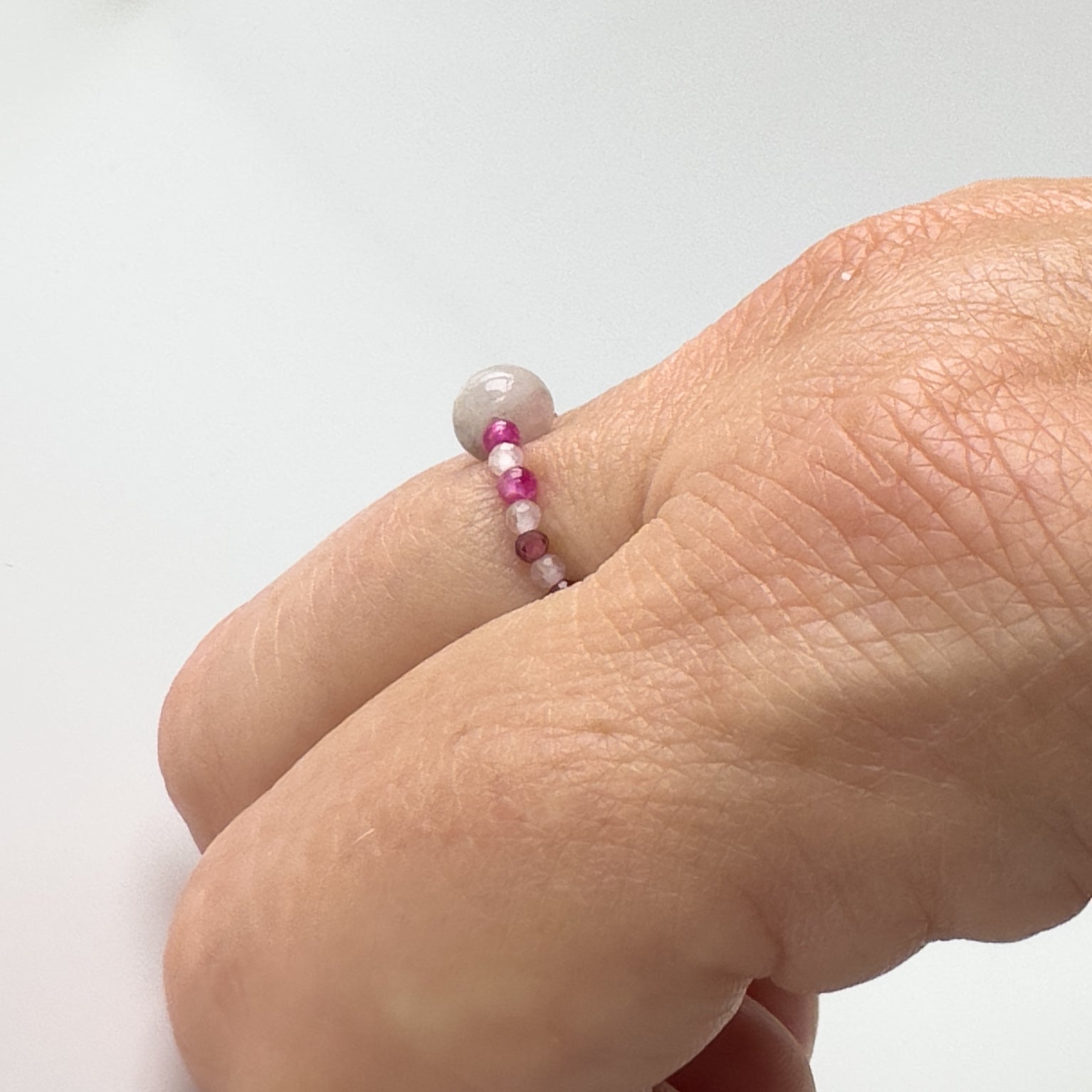 Side view of Leo Birthstone Healing Crystal ring for Love and Compassion on finger