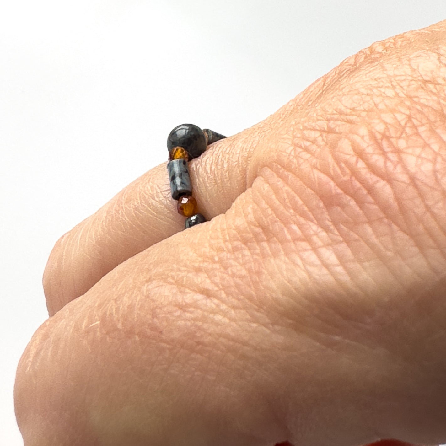 Side view of Scorpio BirthstoneHealing Crystal ring for Strength and Courage on finger
