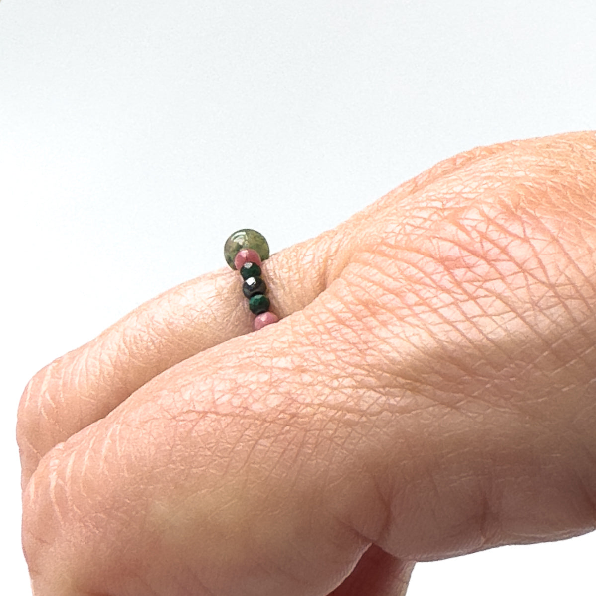 Side view of Scorpio birthstone Healing Crystal ring for Love and Compassion on finger