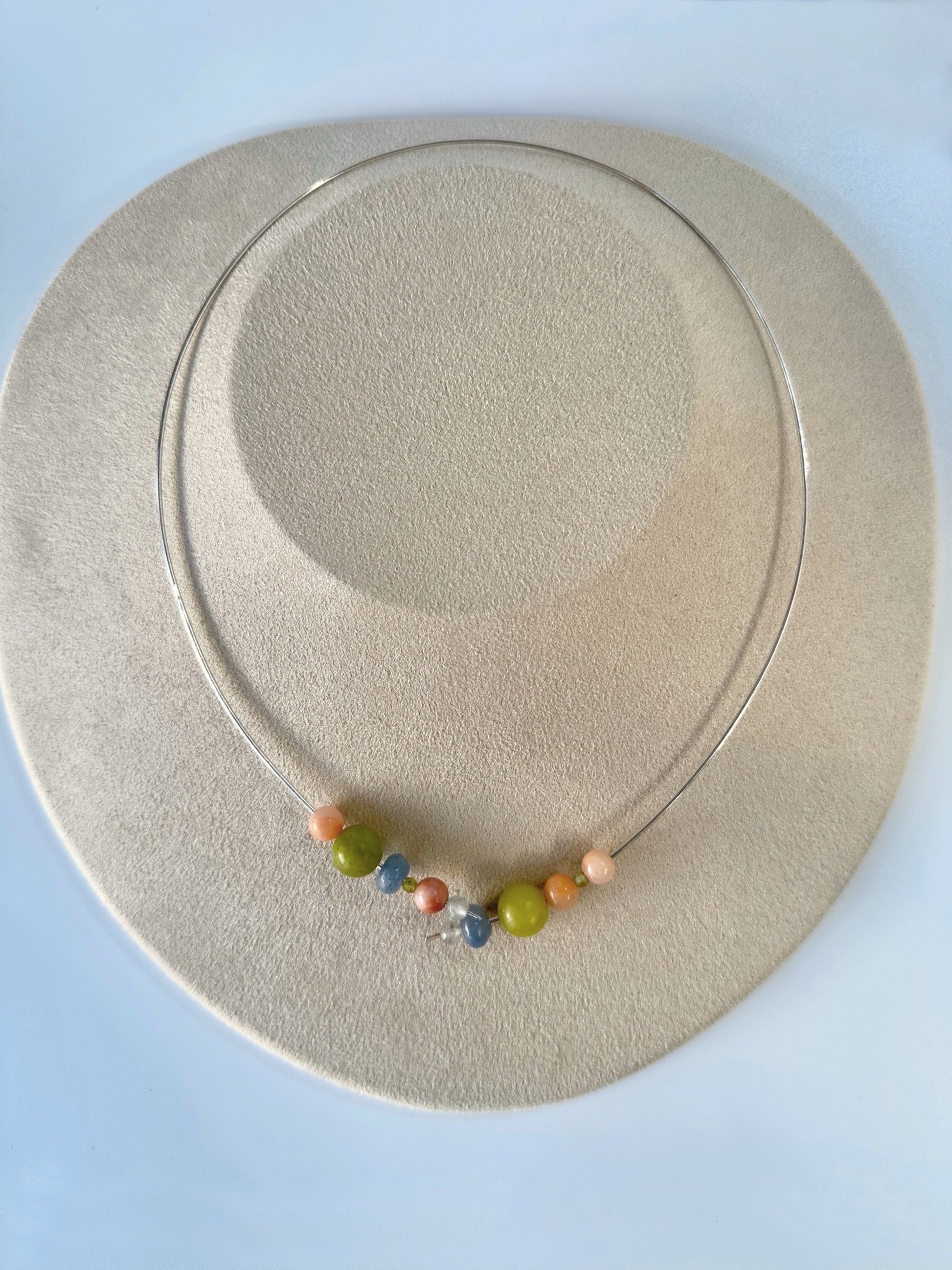 Healing crystal necklace using Leo birthstones for stress on display stand