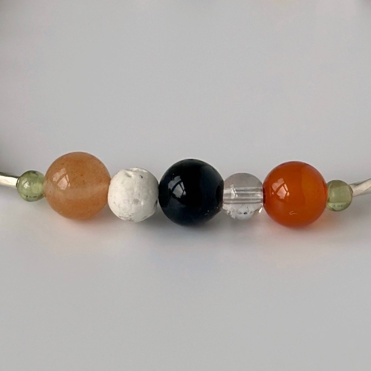 Taurus Birthstone Handmade Healing Crystal bracelet for Determination & Willpower showing Peridot, Carnelian, Blue Tiger’s Eye and Clear Quartz