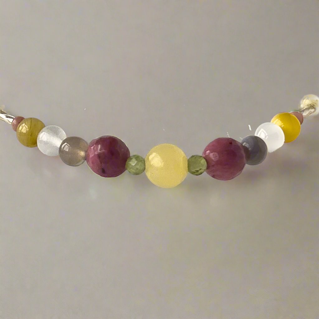 Taurus Birthstone Healing Crystal bracelet for Confidence and Self-esteem showing Yellow Tiger’s Eye, Aragonite, Botswana Agate, Peridot, Rhodonite, Selenite and Clear Quartz