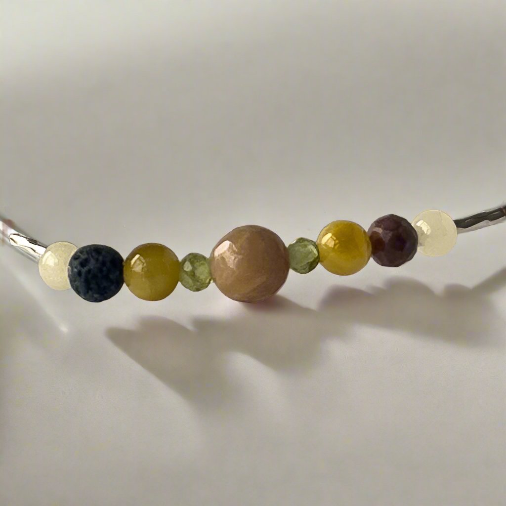Taurus Birthstone Healing Crystal bracelet for Confidence and Self-esteem showing Yellow Tiger’s Eye, Aragonite, Peridot, Rhodonite and Lava Stone
