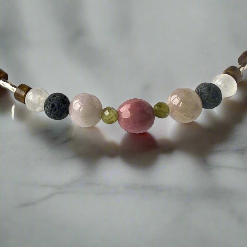 Taurus Birthstone Healing Crystal bracelet for Love and Compassion showing Peridot, Kunzite, Rhodonite, Tiger’s Eye, Lava Stone and Selenite
