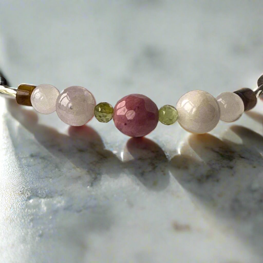 Taurus Birthstone Healing Crystal bracelet for Love and Compassion showing Rose Quartz, Peridot, Kunzite, Rhodonite, Tiger’s Eye and Selenite