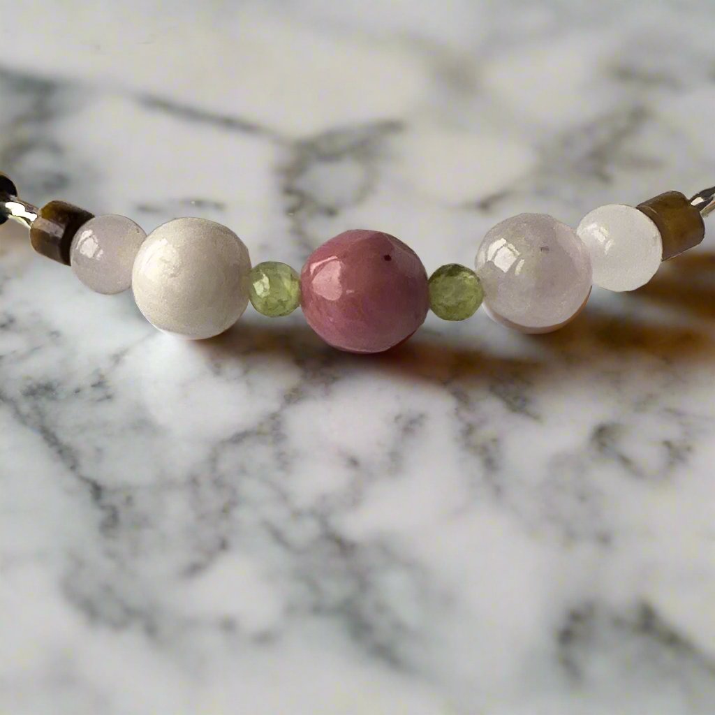 Taurus birthstone Healing Crystal bracelet for Love and Compassion showing Rose Quartz, Peridot, Kunzite, Rhodonite and Tiger’s Eye