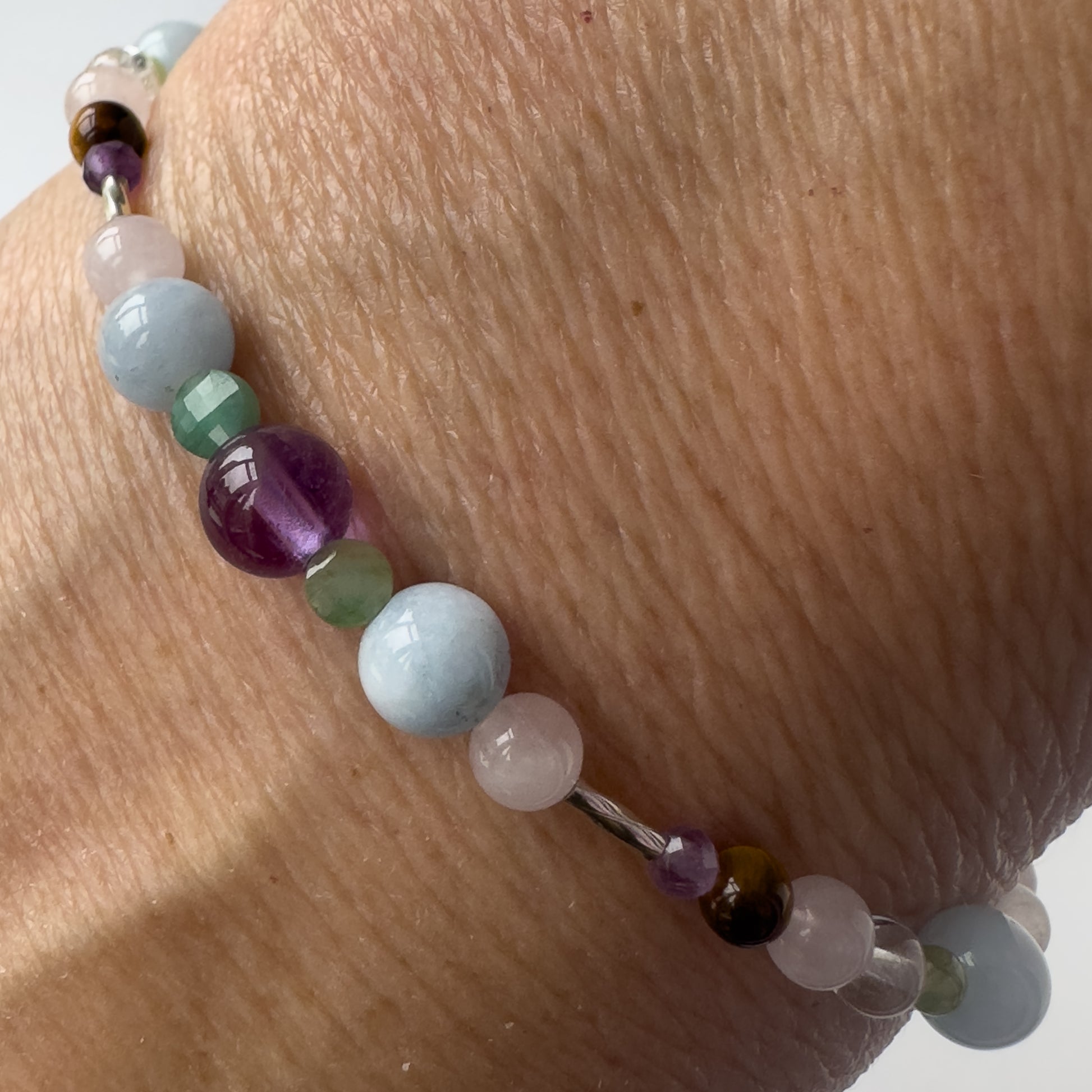 Taurus Healing Crystal bracelet for Stress on wrist showing Emerald, Amethyst, Aquamarine and Rose Quartz