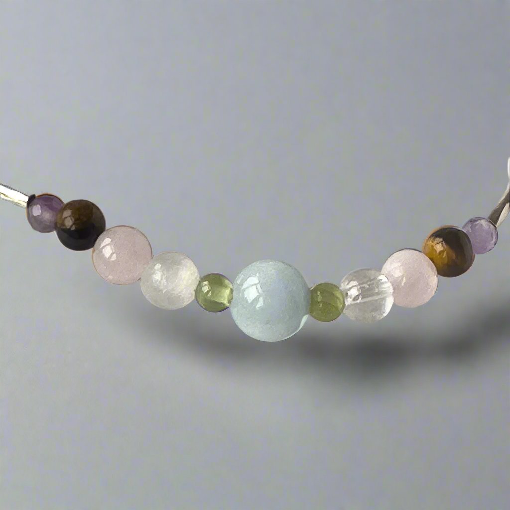 Taurus Birthstone Healing Crystal bracelet for Calm & Stress relief showing Amethyst, Peridot, Aquamarine, Rose Quartz, Yellow Tiger’s Eye, Selenite and Clear Quartz