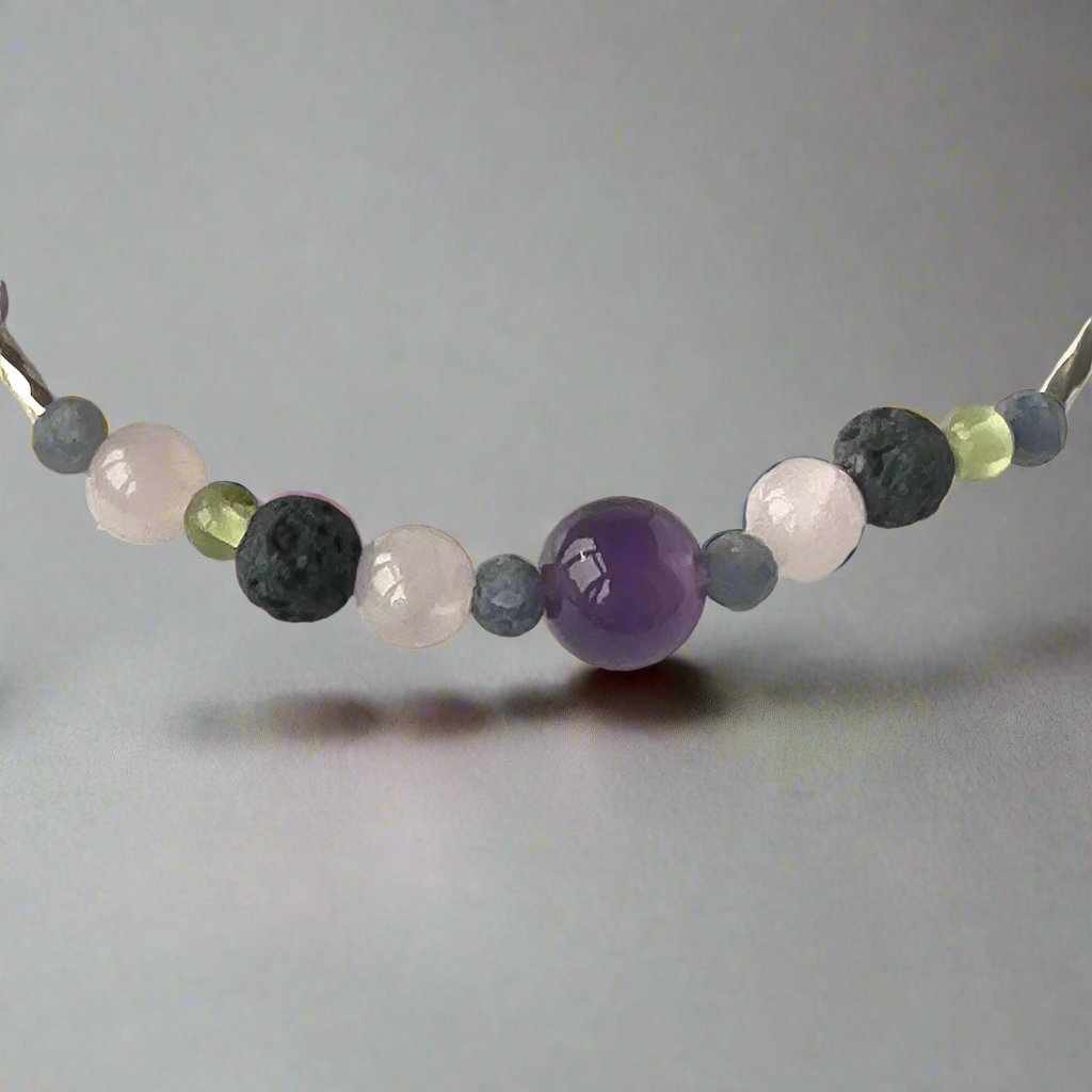 Taurus Birthstone Healing Crystal bracelet for Calm & Stress relief showing Amethyst, Peridot, Rose Quartz, Sapphire and Lava Stone