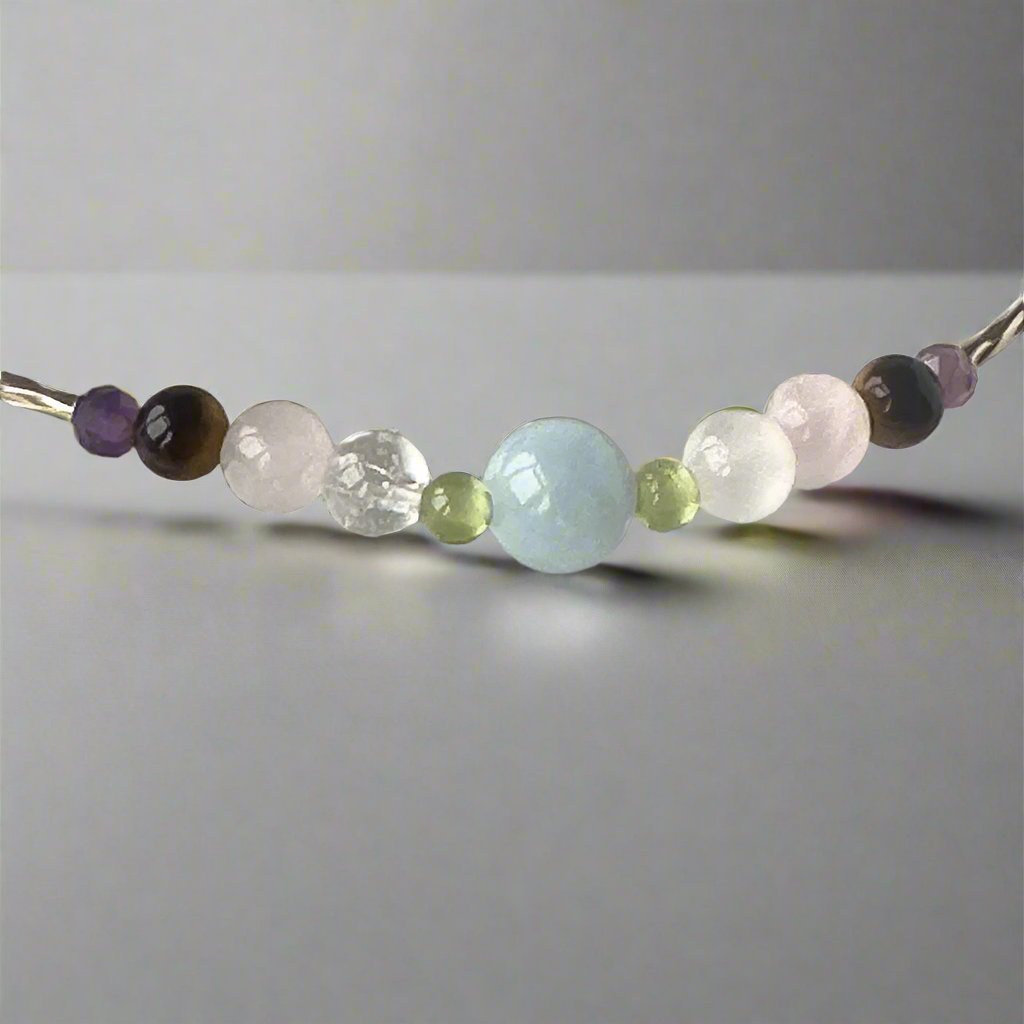 Taurus Birthstone Healing Crystal bracelet for Calm & Stress relief showing Amethyst, Peridot, Aquamarine, Rose Quartz, Yellow Tiger’s Eye, Selenite and Clear Quartz
