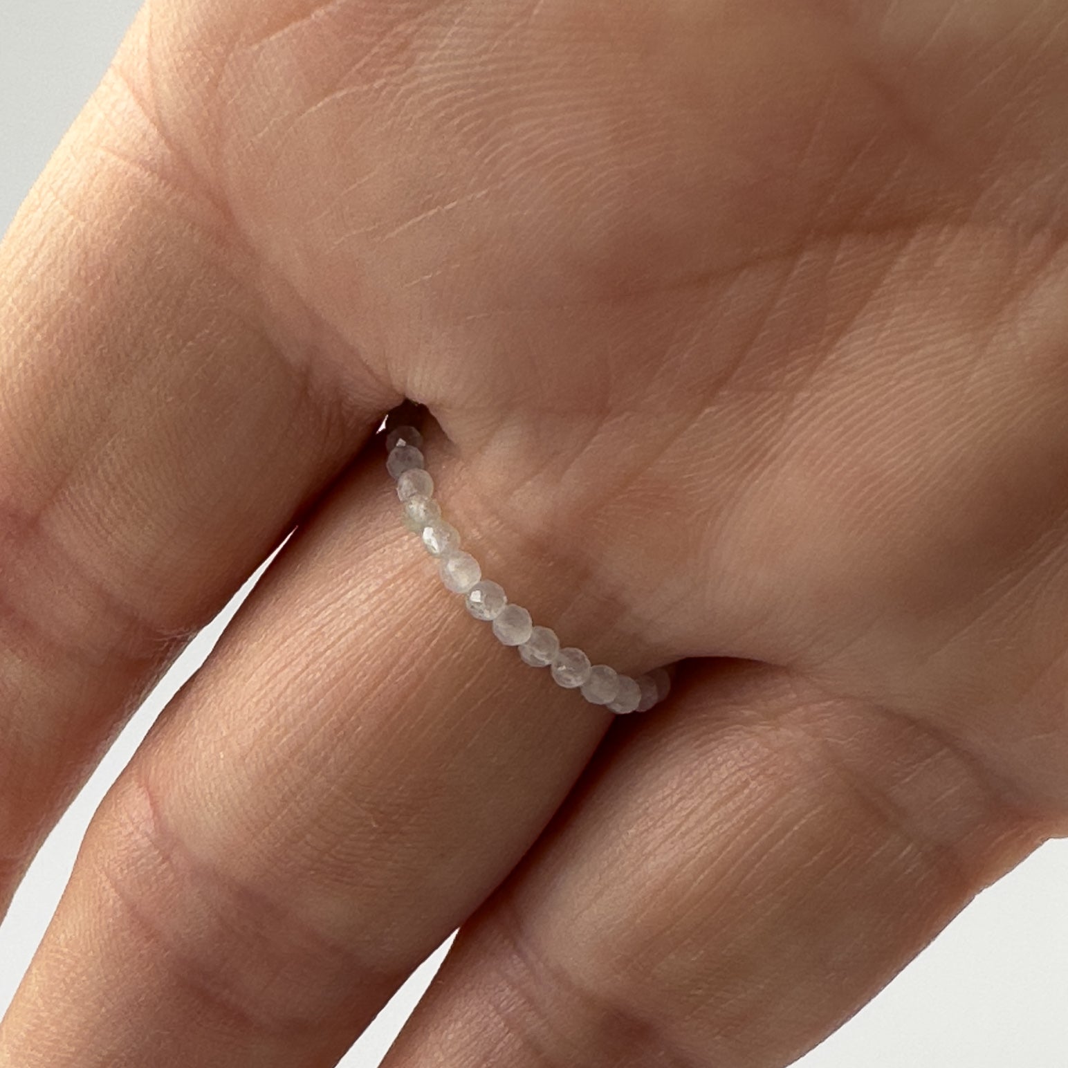 Underside view Cancer Birthstone Healing Crystal ring for Strength and Courage on a finger