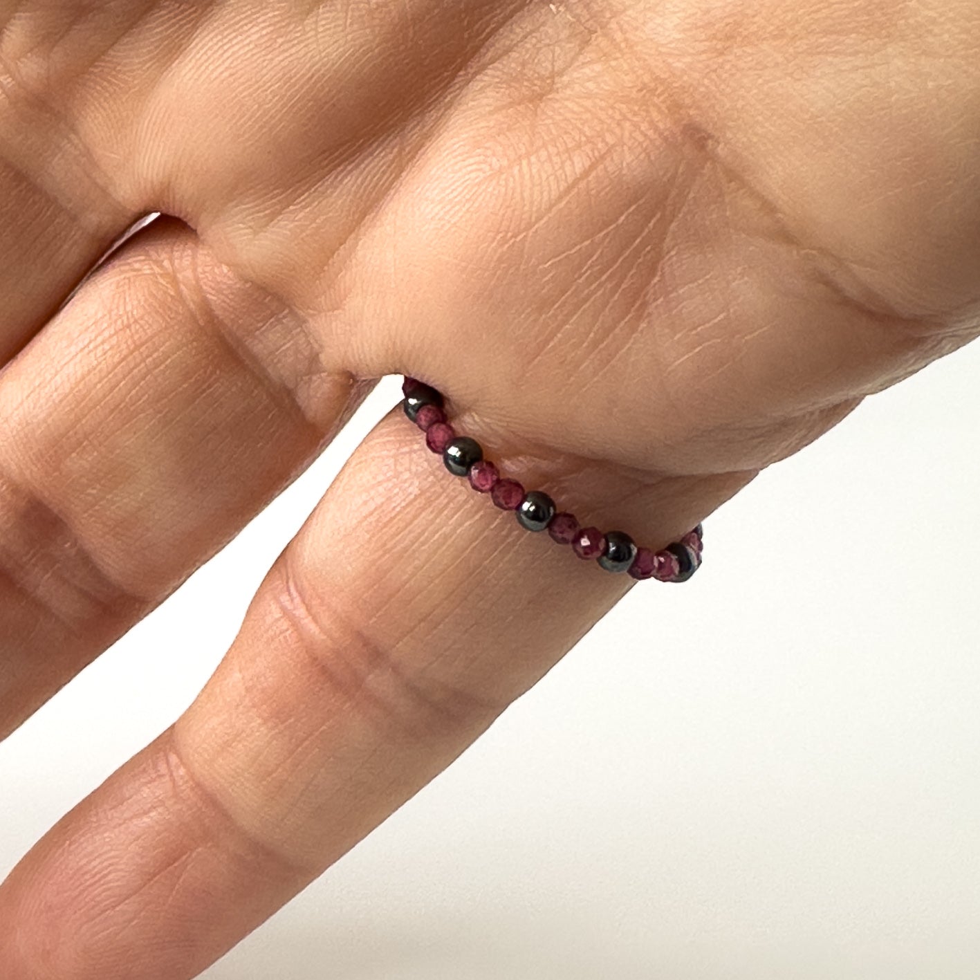 Underside view of Aquarius Birthstone Healing Crystal ring for Strength and Courage on a finger