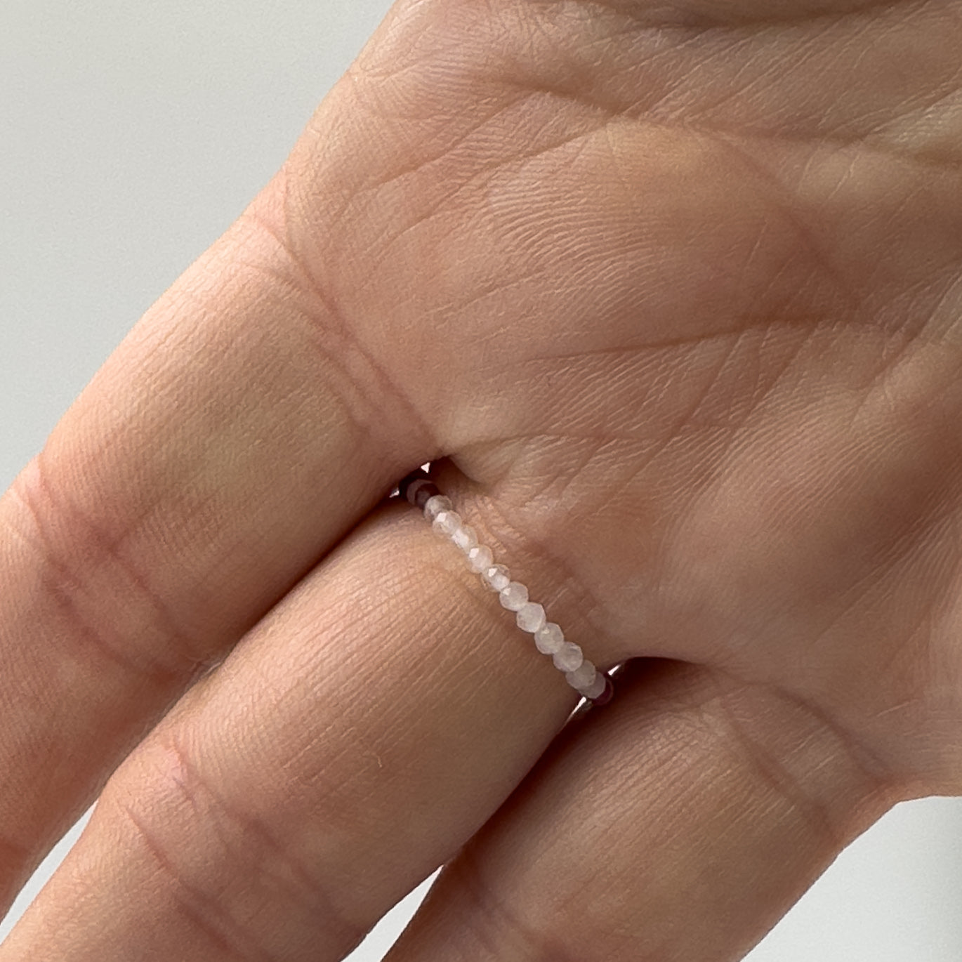 Underside view of Leo birthstone Healing Crystal ring for Love and Compassion on finger