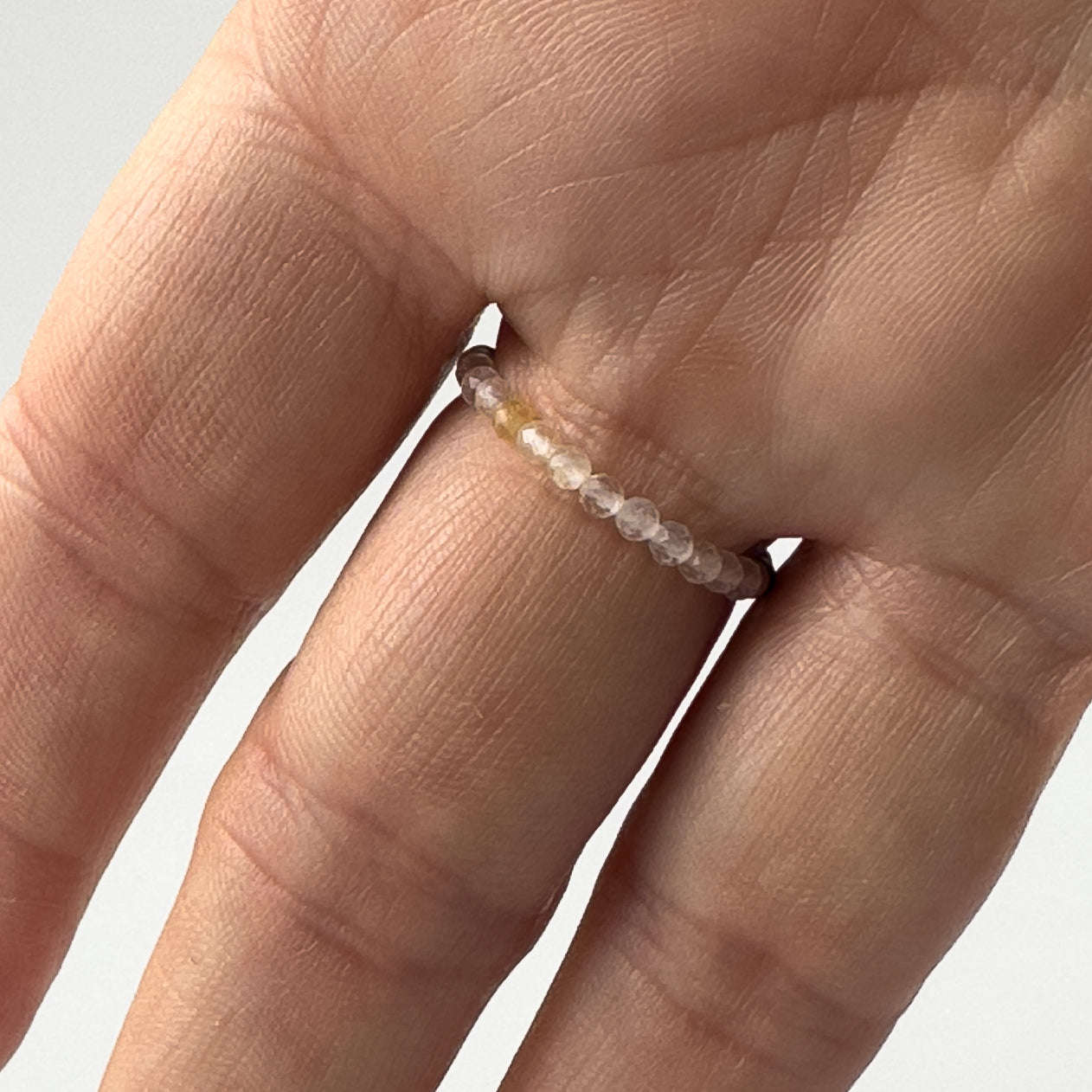 Underside view of Love And Compassion Healing Crystal ring for Libra, Gemini, Leo or Pisces on finger