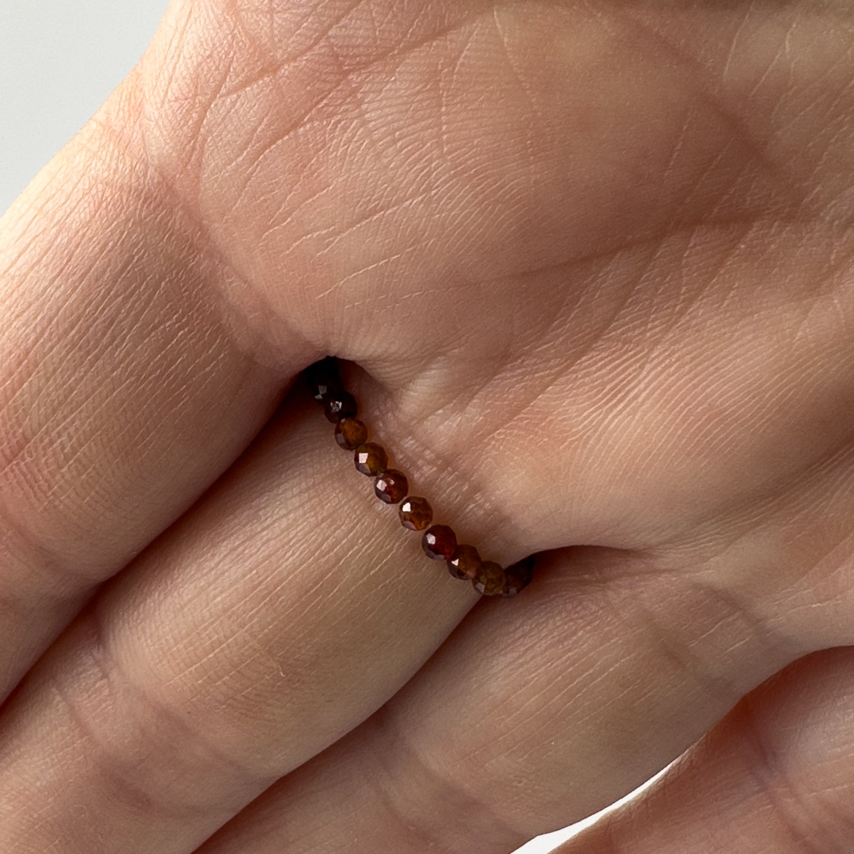 Underside view of Scorpio Birthstone Healing Crystal ring for Strength and Courage on finger