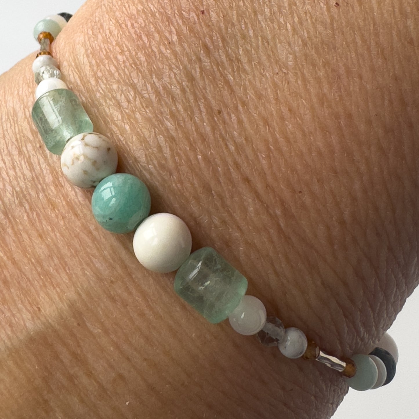 Virgo Healing Crystal bracelet for Stress on wrist showing Howlite, Moonstone, Amazonite, Rainbow Fluorite, Fluorite, Magnesite and Garnet