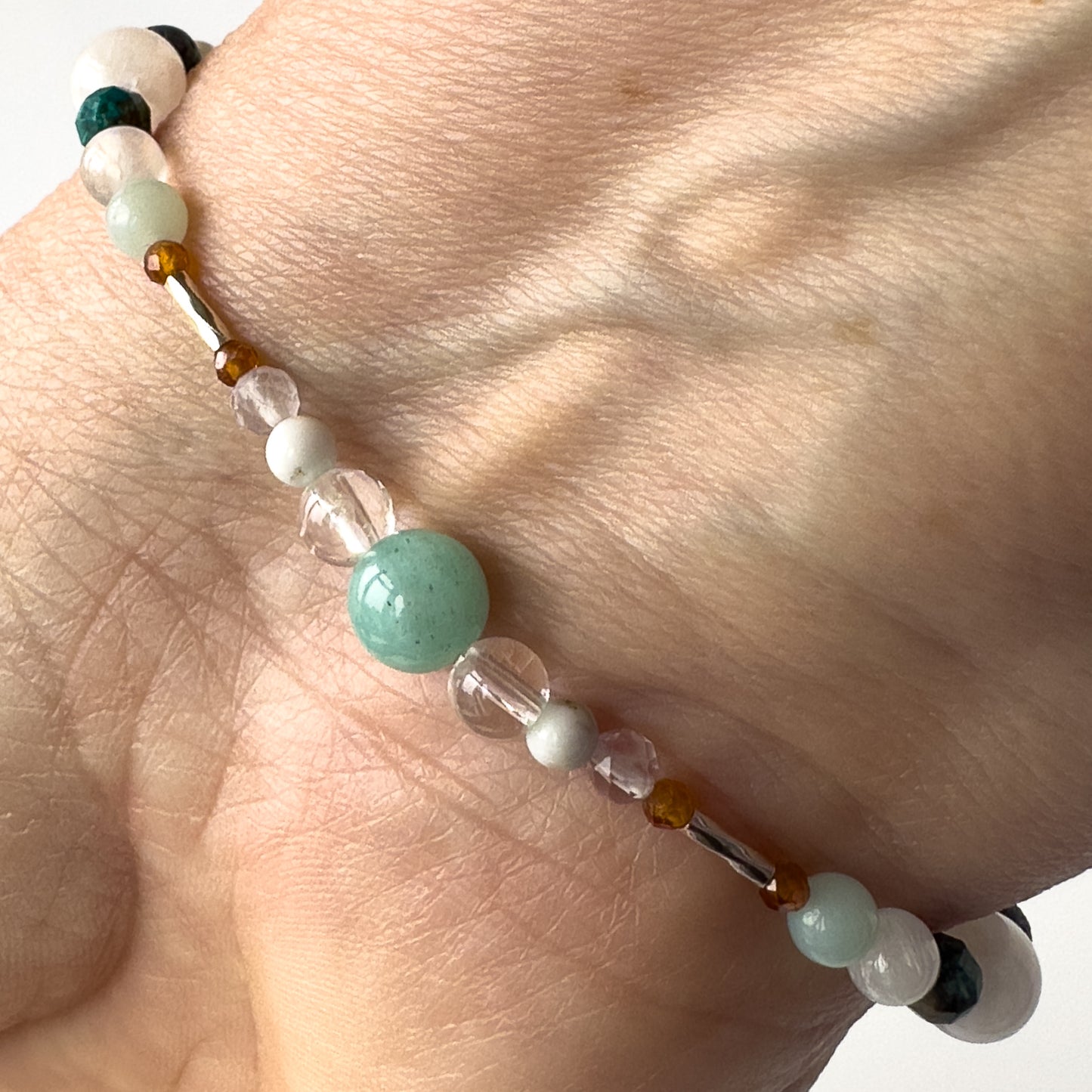 Virgo Birthstone Healing Crystal bracelet for Calm & Stress relief on wrist showing Howlite, Amazonite, Rainbow Fluorite, Garnet and Clear Quartz