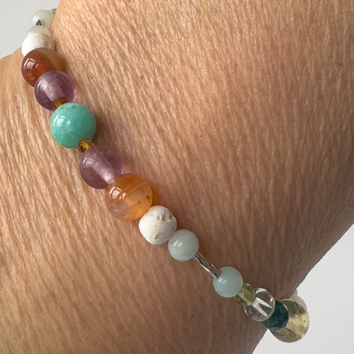 Virgo Healing Crystal bracelet for Willpower on wrist showing Sardonyx, Rainbow Fluorite, Garnet, Amazonite and Lava Stone