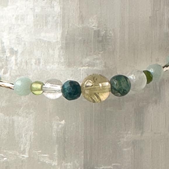 Virgo Birthstone Healing Crystal bracelet for Determination & Willpower showing Peridot, Citrine, Amazonite, Moss Agate, Chrysocolla, Selenite, and Clear Quartz
