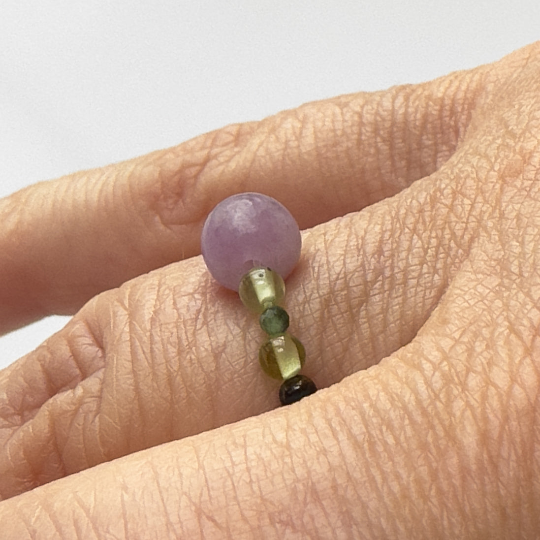 side view of Love and Compassion birthstone Healing Crystal ring for Pisces or Libra on finger