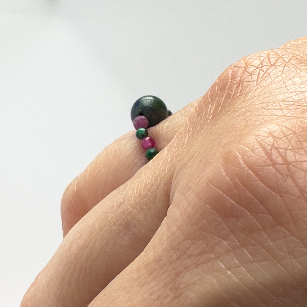 side view of Love and Compassion Healing Crystal ring for Sagittarius or Capricorn on finger