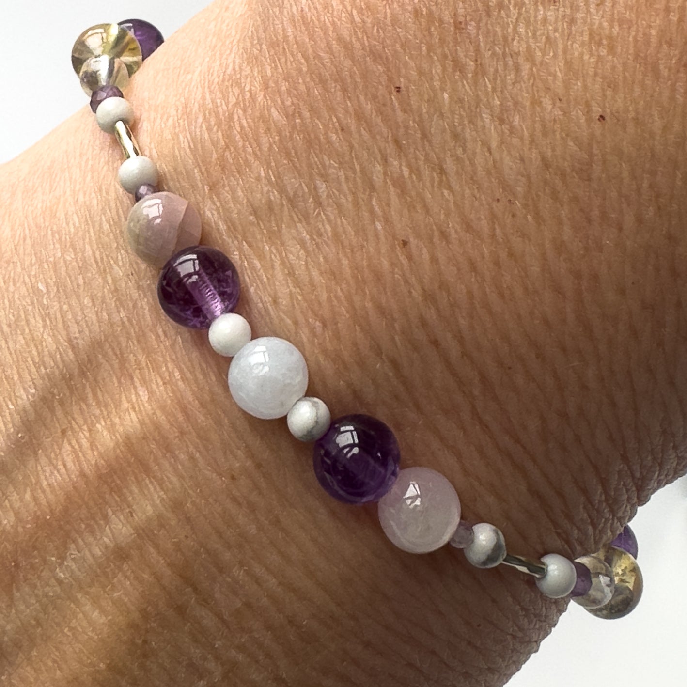Close-up of Healing crystal bracelet showing Amethyst, Howlite, Kunzite and Citrine
