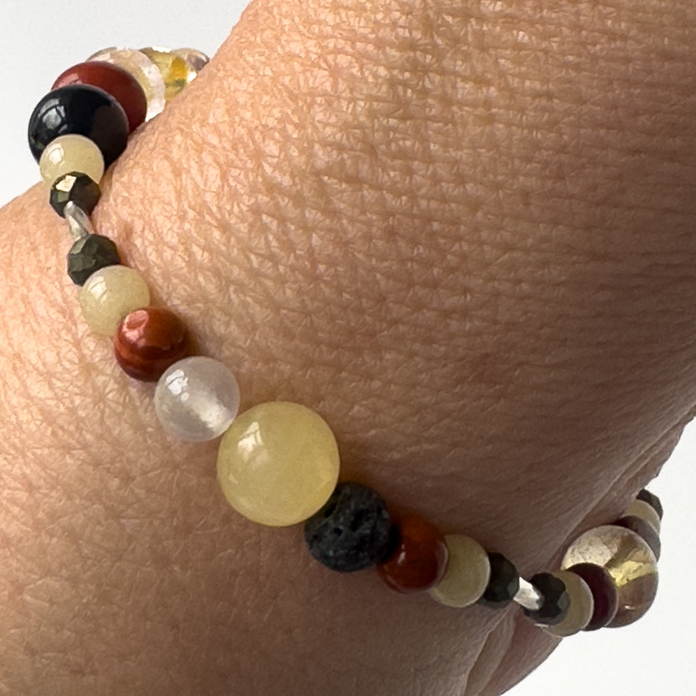Aries Birthstone Healing Crystal bracelet for Confidence and Self-esteem showing Iron Pyrite, Jasper, Aragonite, Selenite and Lava Stone on a wrist