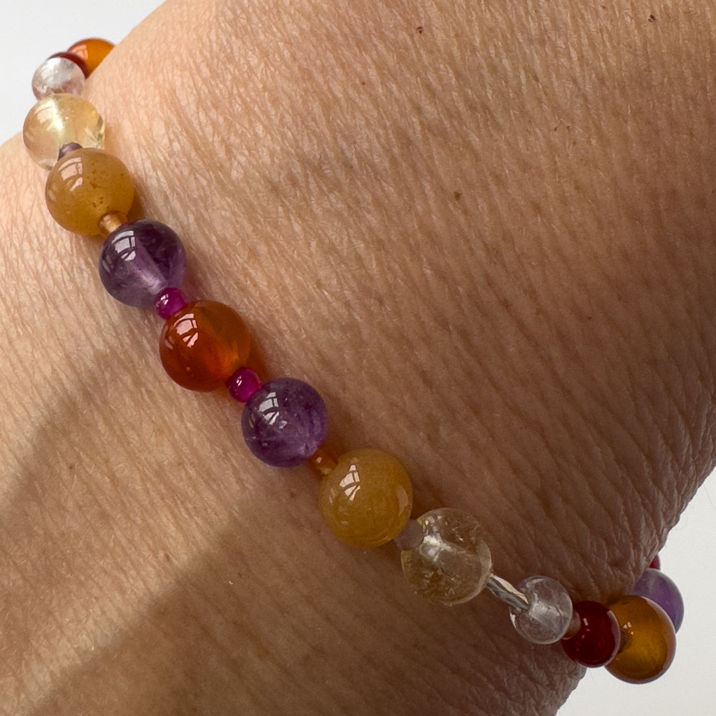Aries Healing Crystal bracelet for Grief & Loss on a wrist showing Amethyst, Ruby, Citrine, Carnelian and Clear Quartz