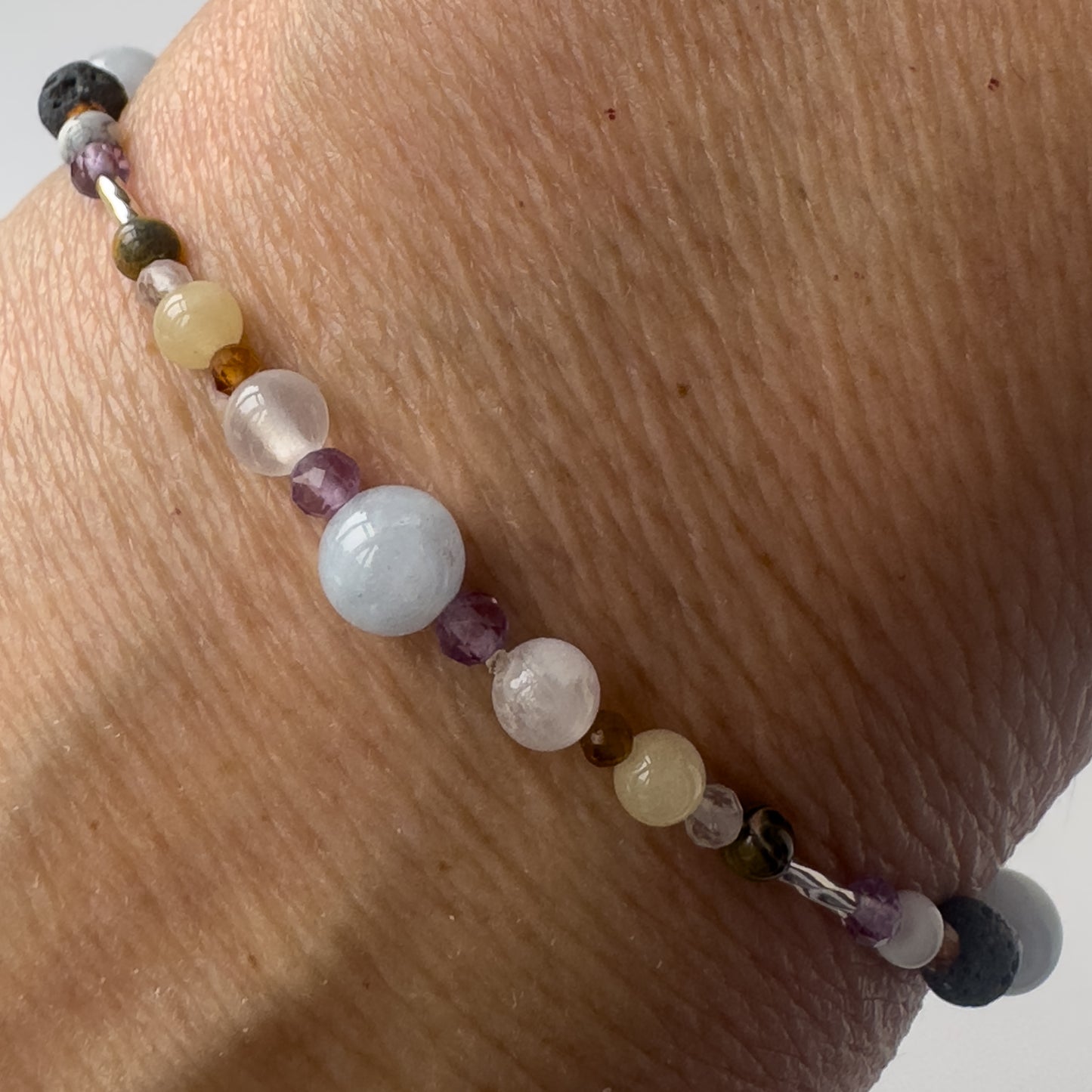 Aries Healing Crystal bracelet for Stress Close-up of Aquamarine, Amethyst, Leopardskin Jasper, Aragonite, Garnet, Selenite and Clear Quartz