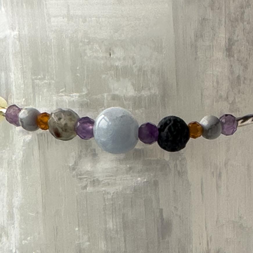 Aries birthstoneHealing Crystal bracelet for Calm & Stress relief showing Aquamarine, Bloodstone, Amethyst, Howlite, Garnet and Lava Stone