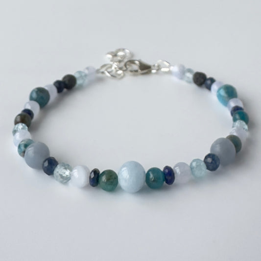 Beaded bracelet with multicolored beads on a light gray background