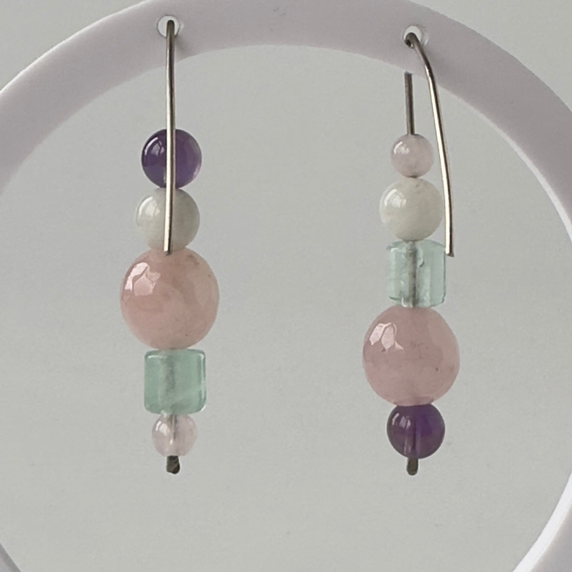 Pair of earrings with multicolored beads on a white background