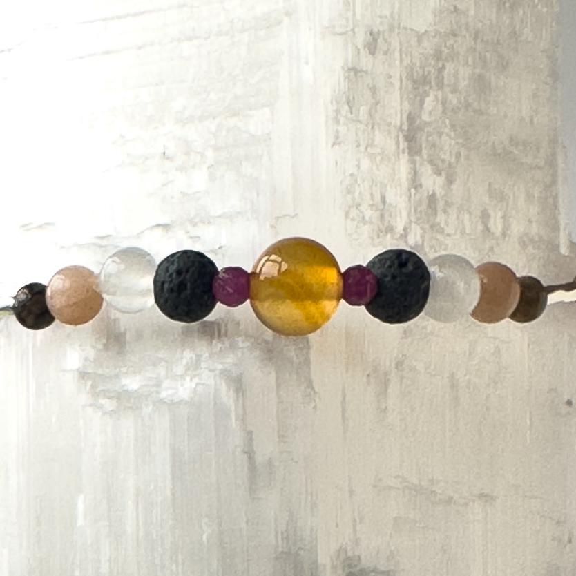 Cancer Birthstone Healing Crystal bracelet for Determination & Willpower showing Carnelian, Ruby, Leopardskin Jasper, Sunstone, Selenite and Lava Stone