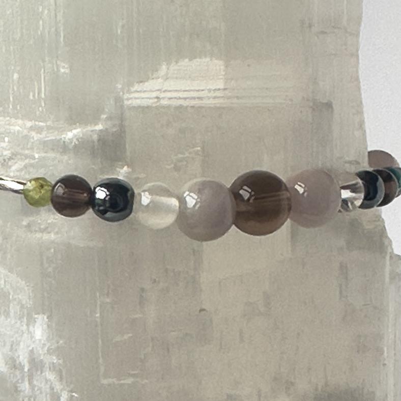 Scorpio Healing Crystal bracelet for Anxiety showing Smoky Quartz, Peridot, Hematite, Kunzite, Selenite and Clear Quartz